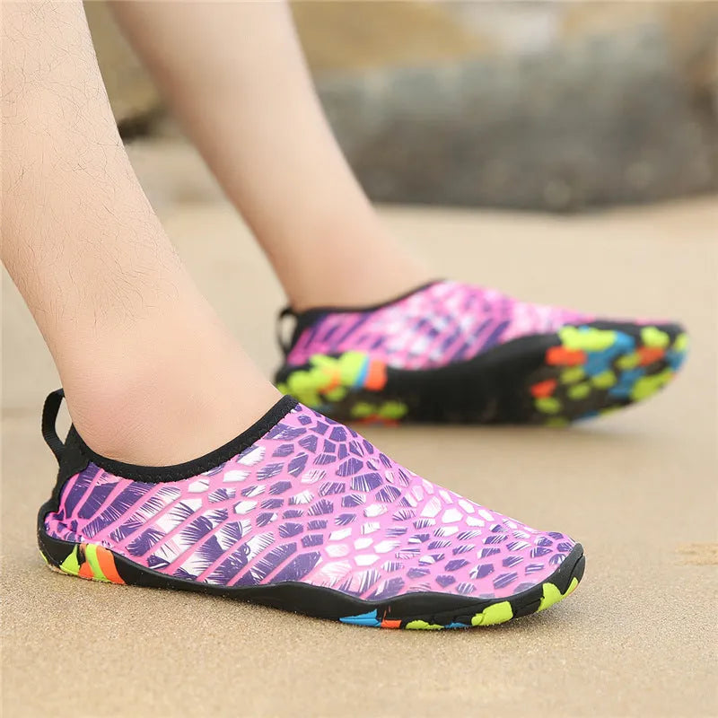 Blue Lycra beach wading shoes with EVA midsoles on a sandy background.
