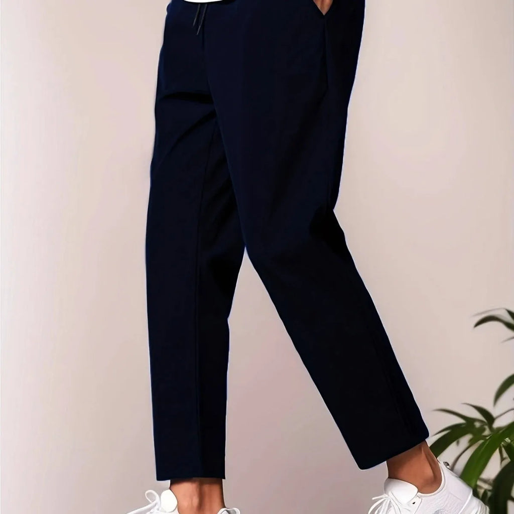 Men's slim fit ankle length trousers in black polyester, tapered leg, mid waist, cropped cut.