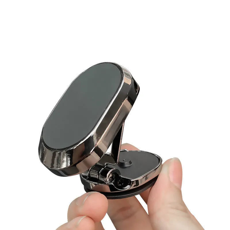 Folding magnetic phone holder in black on car dashboard with phone attached