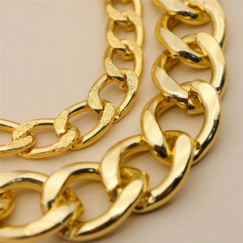 Three gold alloy double-layer thick chain bracelets with geometric design laid out flat