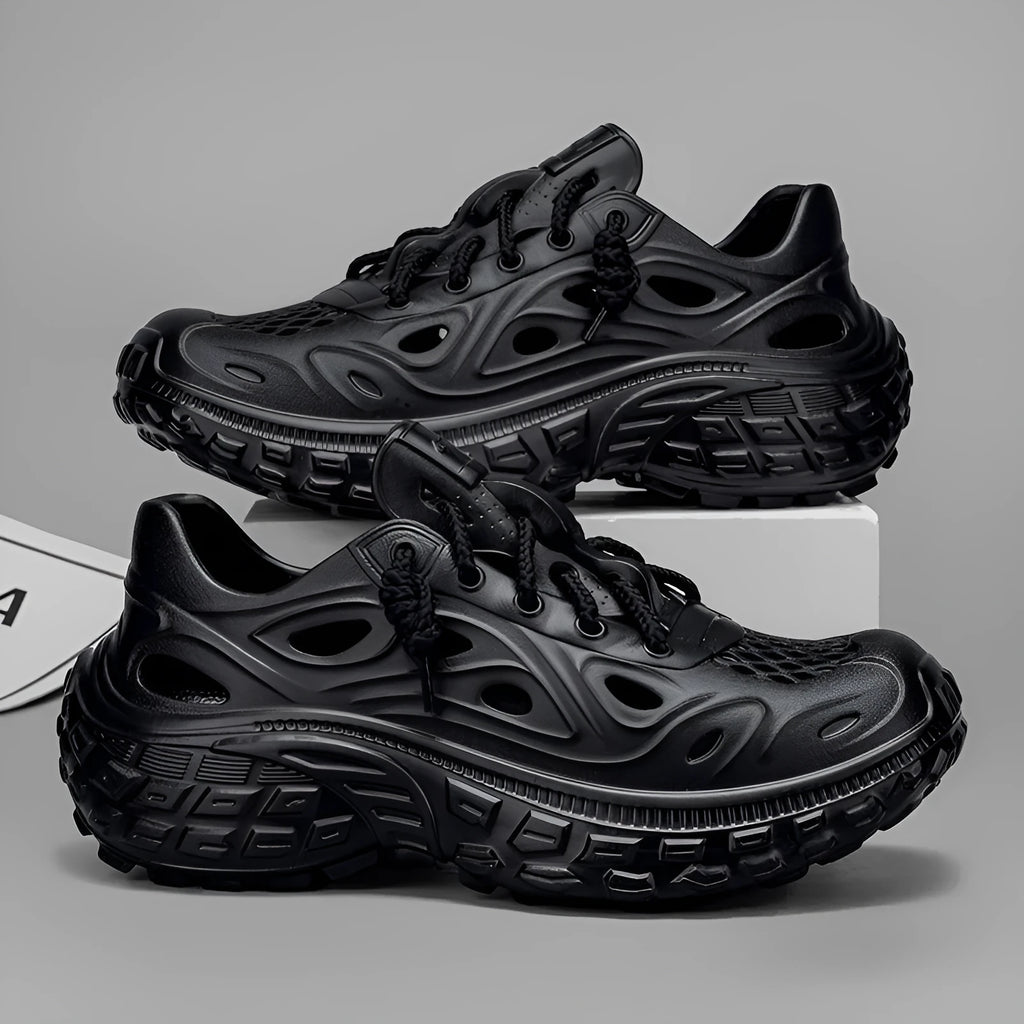 Men's black EVA sandals with a hollow out design and thick sole, shown on a foot.