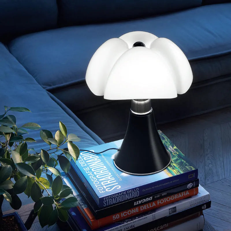 Italian retro flower design table lamp in a choice of colours on a bedside table.