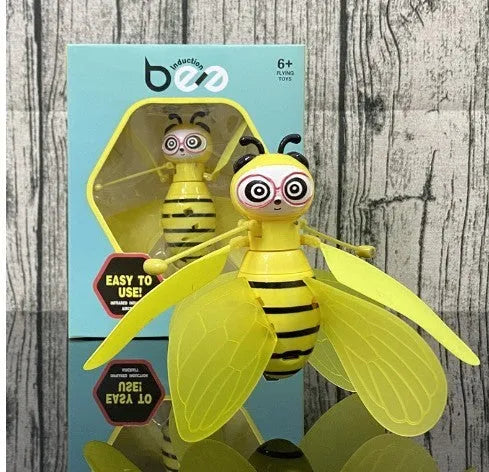 Yellow mini flying ball bee drone with infrared gesture sensing, ABS plastic body, and removable wings on a white background