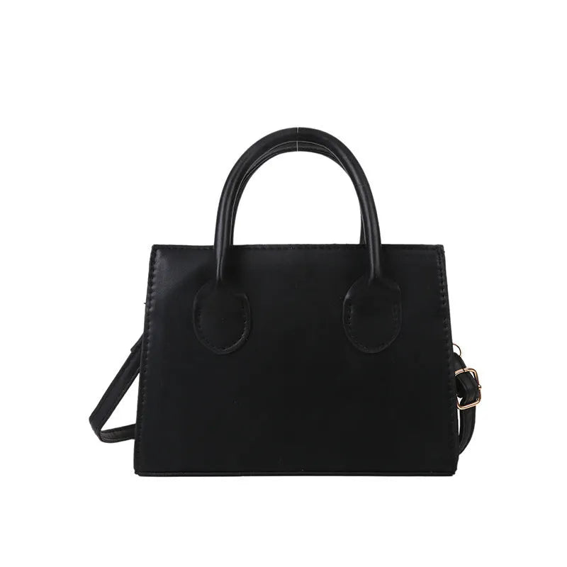 Small square shoulder bag in PU leather with single strap and document pocket, shown in available colours