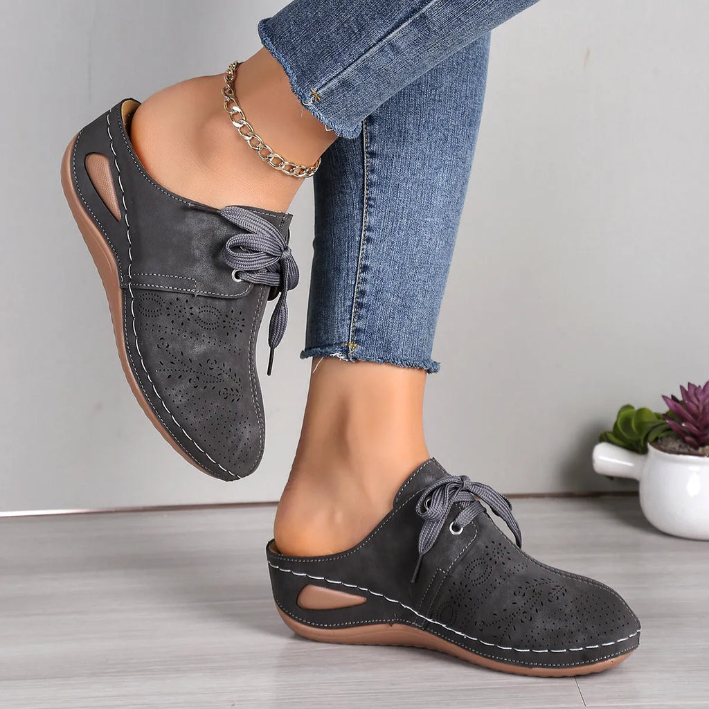 Women's suede lace-up wedge slippers in light grey with a hollow out design and rubber sole.
