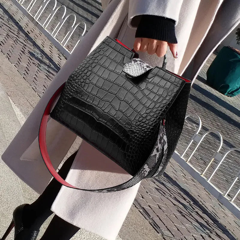 Black women's messenger bag bucket shape with colour contrast detailing and zipper closure