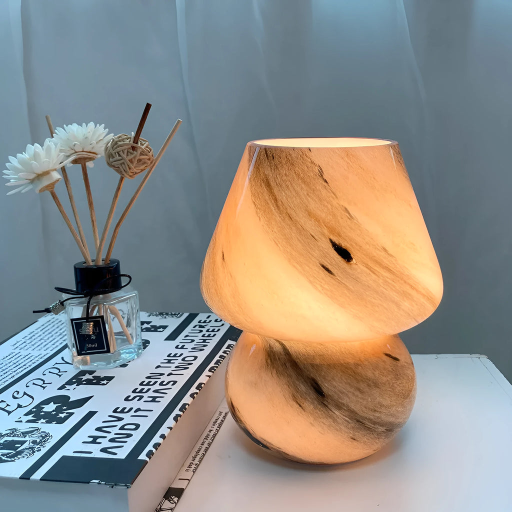 Handmade glass mushroom table lamp in Earth colour on wooden bedside table, 15cm by 19cm