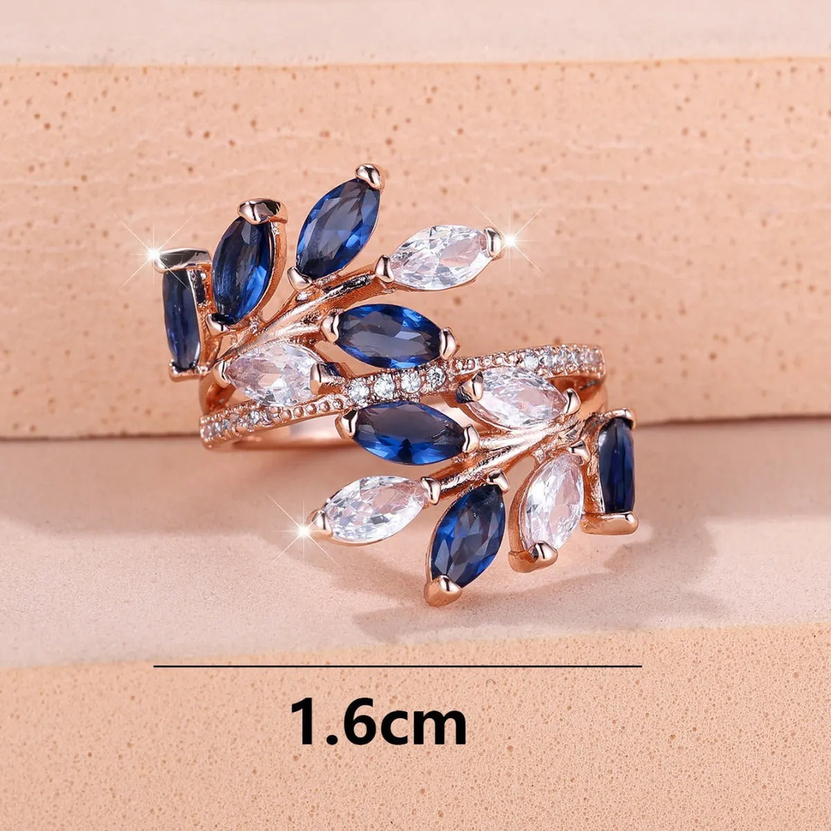 Adjustable copper leaf ring with a horse eye zircon stone in multiple colour finishes on a neutral background.