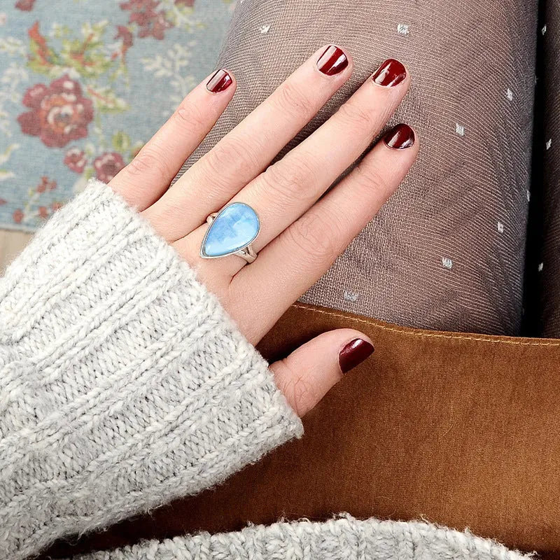 Women's copper drop-shaped geometric ring in electroplated A077 white gold colour, side view on white background