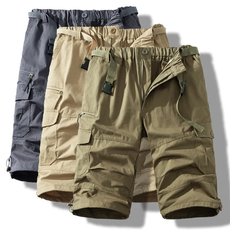 Man wearing thin cotton cropped overalls in army green, showing the relaxed summer fit.
