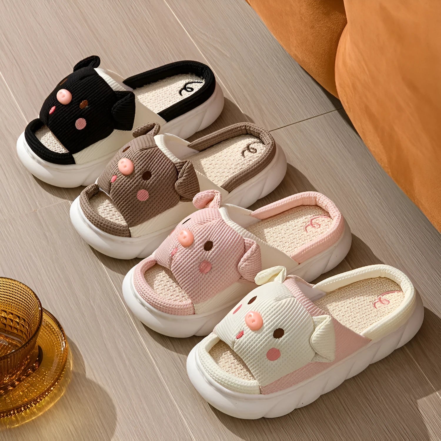 White linen open toe flip flop slippers for couples on a light background, showing PVC sole and strap detail.