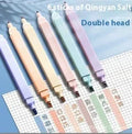 Set of double-ended fluorescent highlighting pens in mixed colours on a white surface.