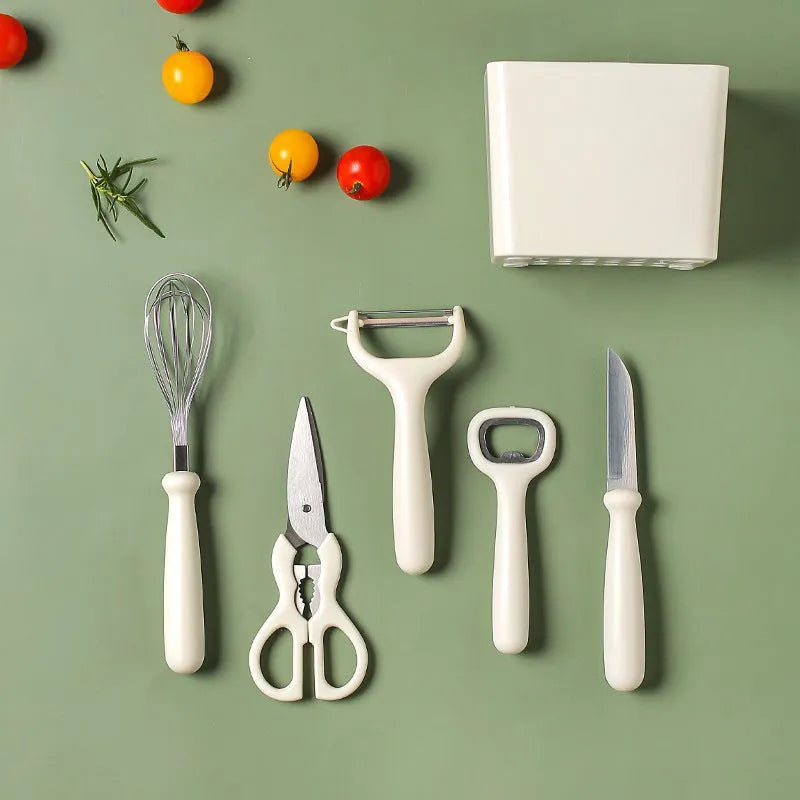 Six-piece white stainless steel kitchen gadget set arranged on a neutral background