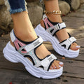 Women's white Roman platform sandals with strap design and rubber sole on a neutral background.
