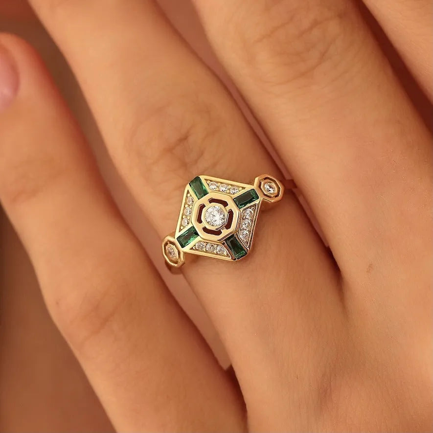 Square geometric emerald diamond ring in lvzuan colour on a model's finger.