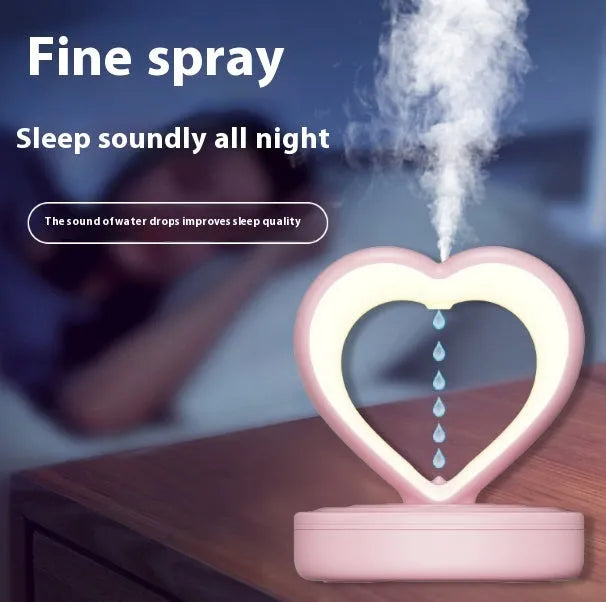 Love Anti Gravity humidifier, heart shaped with water droplet backflow, white colour, with ambience light, on a wooden desk
