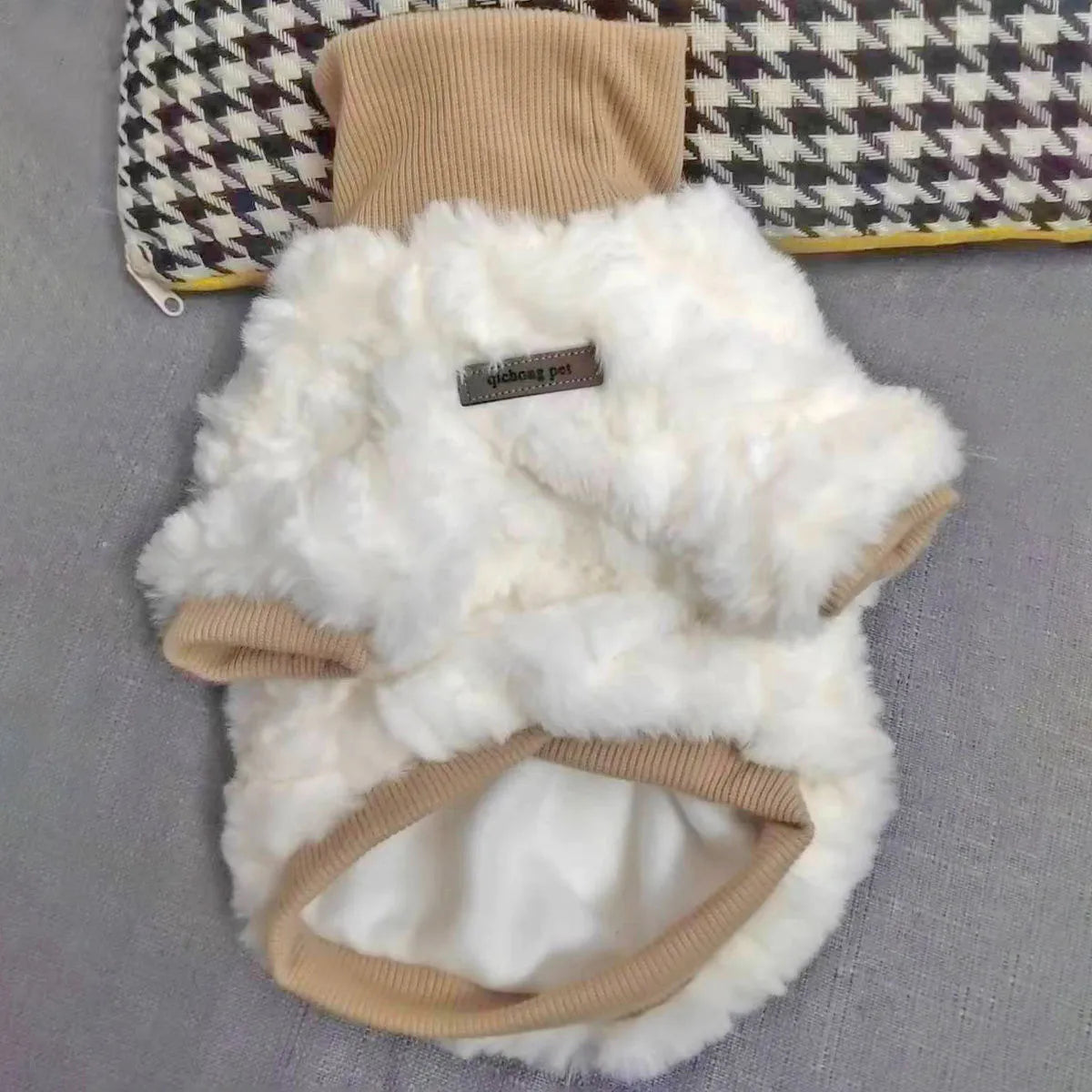 Creamy green turtleneck plush dog coat on a small dog, showing high collar design