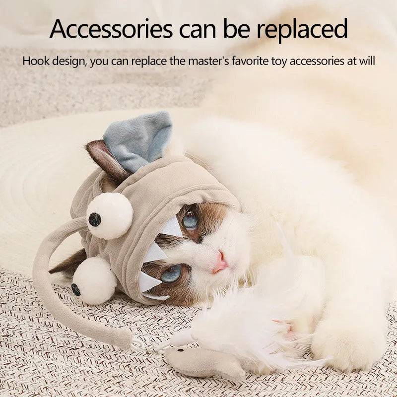 Grey head-mounted cat toy with feather and big-eye fish attachments on adjustable elastic band