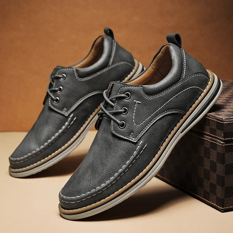 Men's black genuine leather lace-up casual shoes with round toe and low rubber sole on a white background.