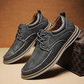 Men's black genuine leather lace-up casual shoes with round toe and low rubber sole on a white background.