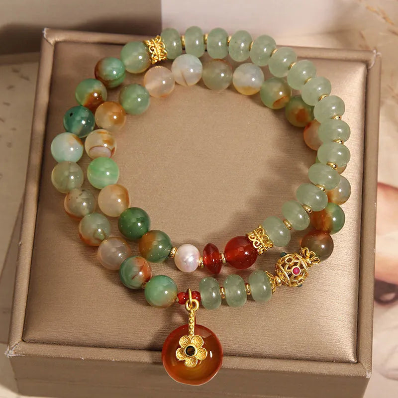 Peacock green agate double ring bracelet for women with safety buckle clasp and rhinestone details.