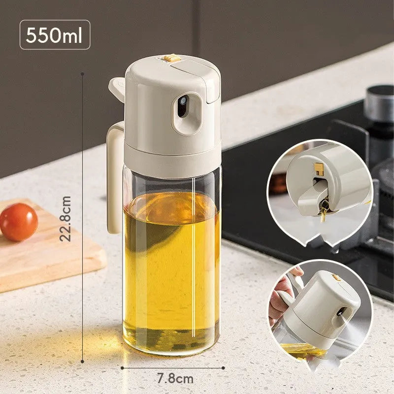 Warm grey glass oil spray bottle with a black lid and switch for selecting spray or pour mode.
