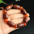 Distressed agate Tibet bead bracelet with three-eye design and polished finish on a wrist.