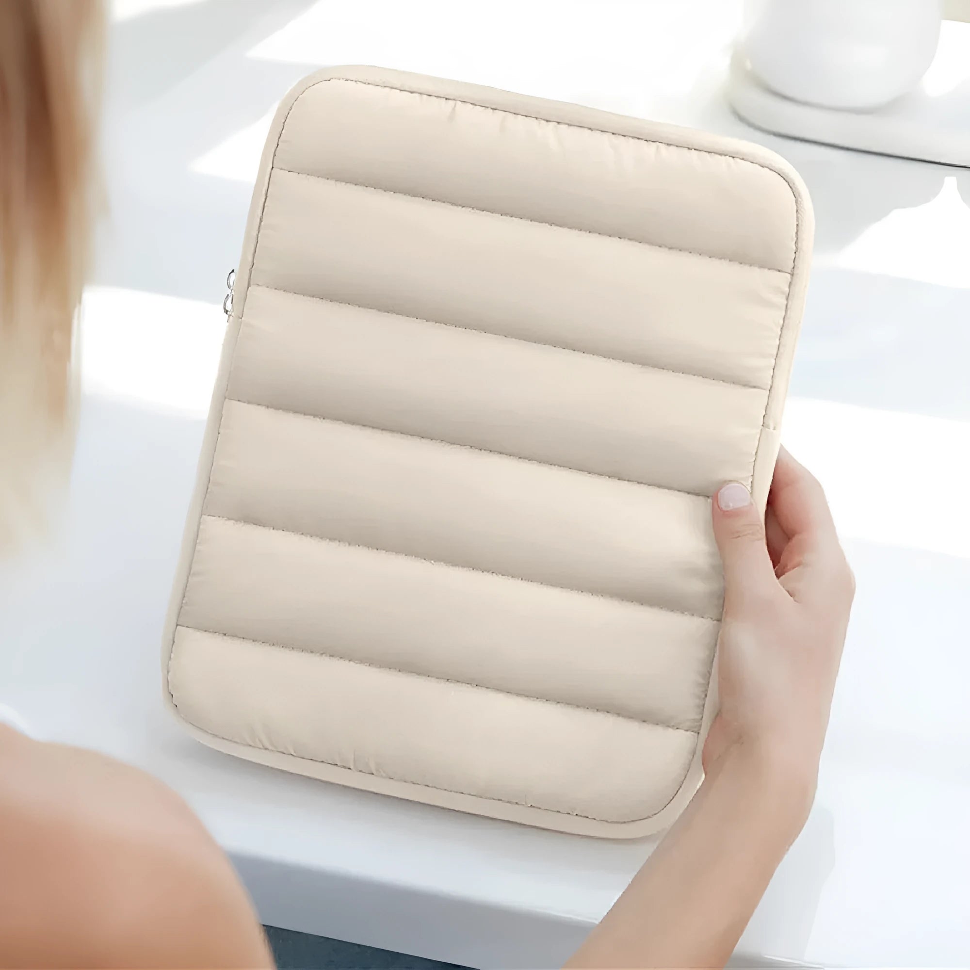 Puff bag laptop sleeve in black showing elastic sides and padded construction for 9.7-11 inch devices
