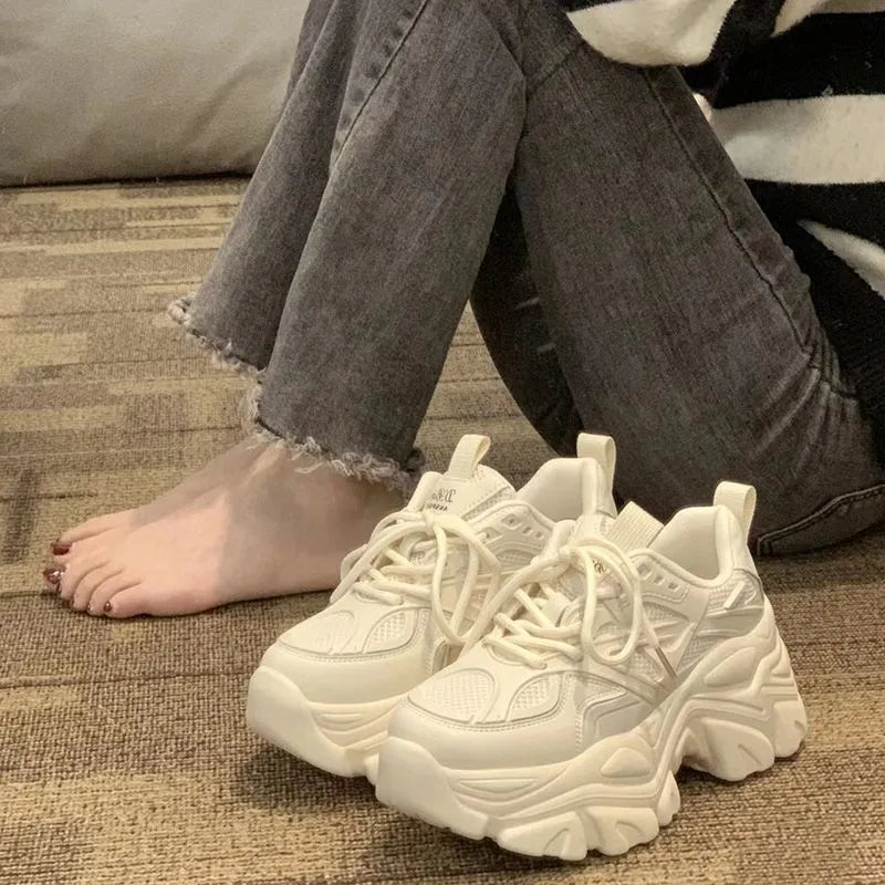 Mid-top platform trainers with 6-8cm high heel, cross strap synthetic leather upper, Goodyear rubber sole, black or creamy white