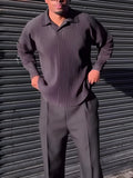 Men's black polyester long-sleeved top with pleated design detail showing regular fit and long sleeves