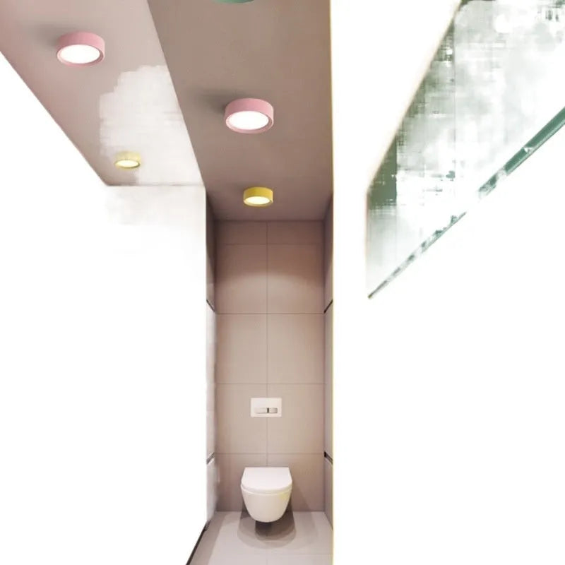 Ultra-thin surface mounted LED downlight in a choice of seven colours including black, white, gold, and pink.