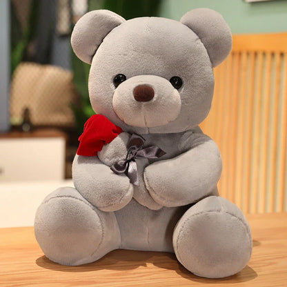 Plush teddy bear pillow with rose design, available in brown, beige, and grey colors in three sizes