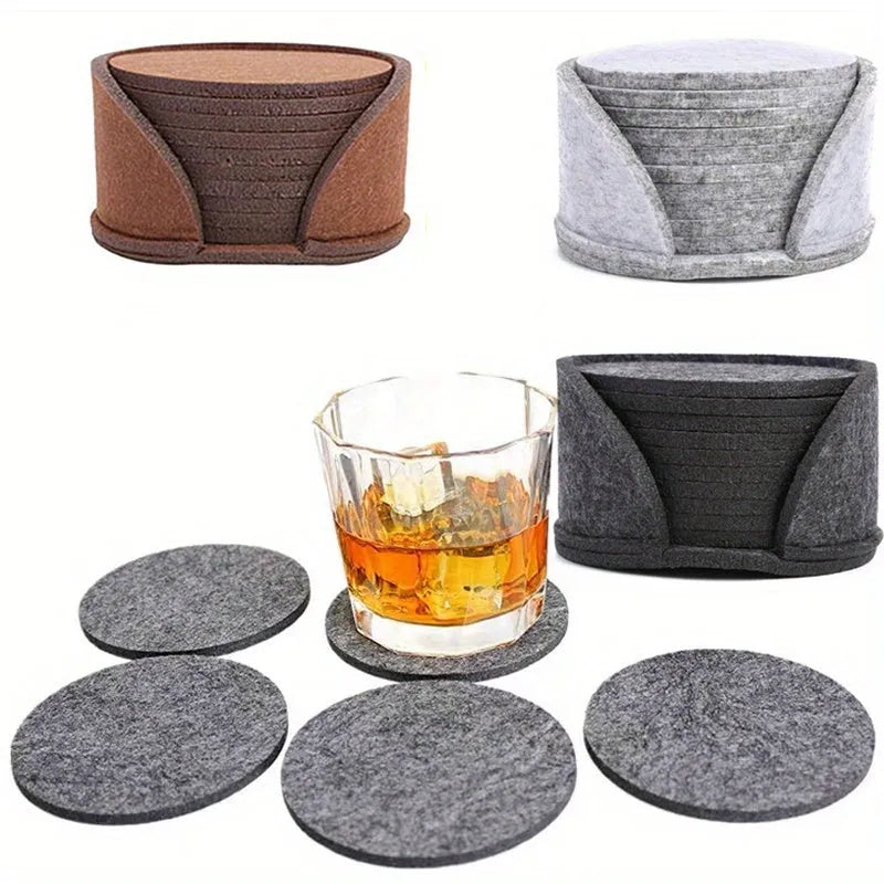 Round felt coaster set of 10 heat resistant drink mats in black, brown, dark gray, and light gray on a wooden table