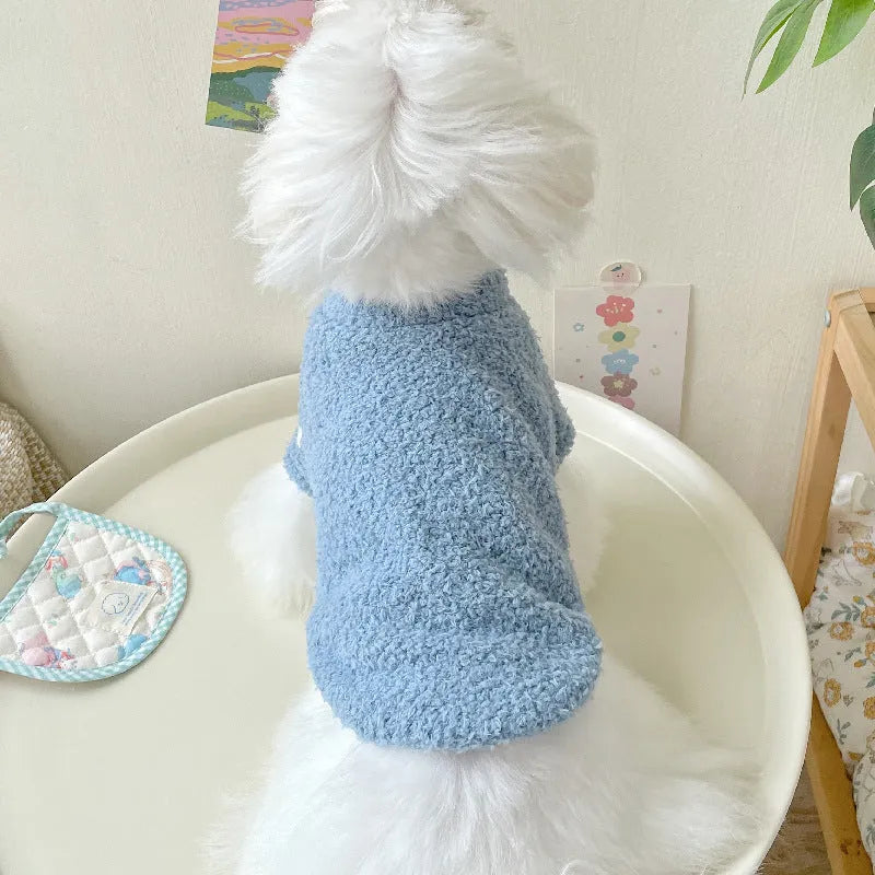 A small dog wearing a double-sided cloud velvet thickened jacket in one of six available colours.