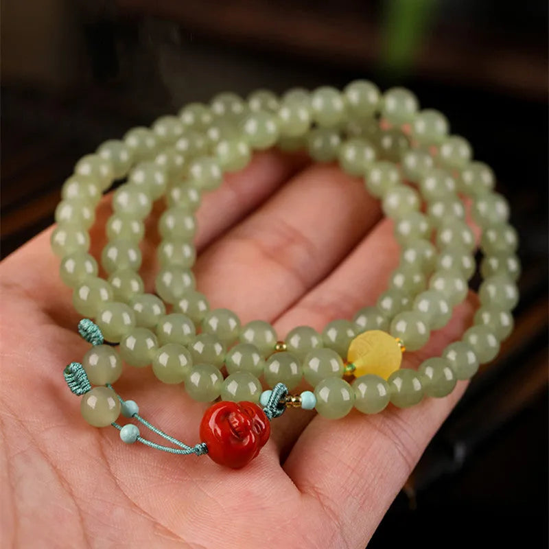Pale blue Hetian Jade bracelet with 6mm beads arranged in three-circle pattern on elastic string