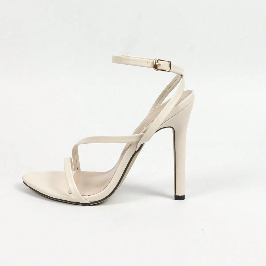 Gold women's high heels with crossed ankle straps and an open round toe on a rubber sole.