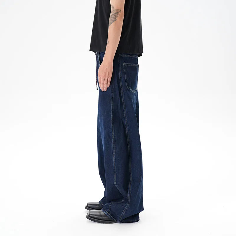 Dark blue wide leg distressed jeans on a hanger showing washed denim fabric and machete cut.