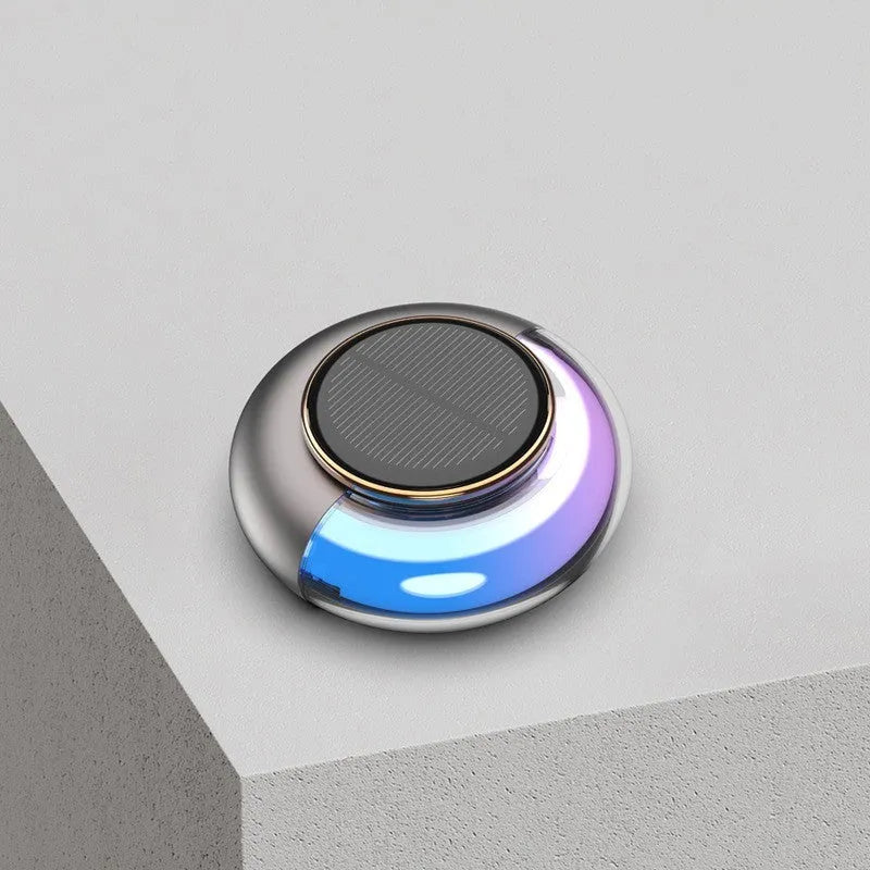 Car solar charging fragrance with built-in motor, round shape, grey colour, on car dashboard