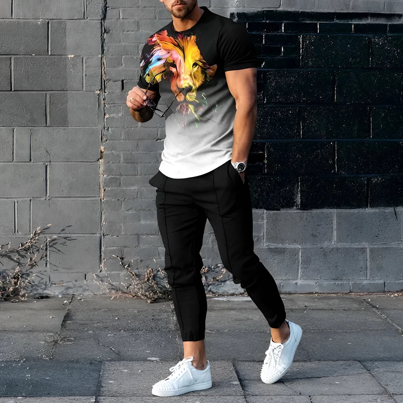 Man wearing a short-sleeved printed round neck T-shirt and matching trousers from a cotton-like polyester suit.