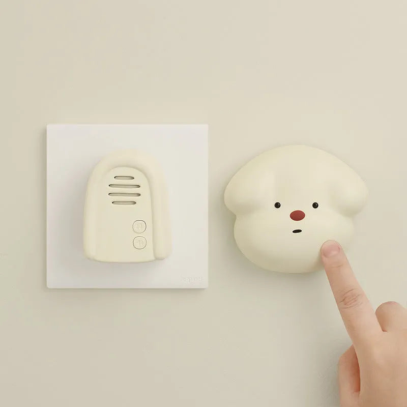 Household wireless doorbell unit with plug-in receiver in milky yellow or white colour.