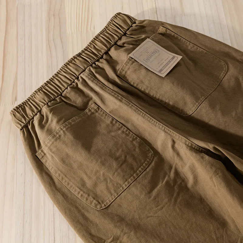 Men's Army Green cotton overalls with drawstring waist and banded ankles laid flat.