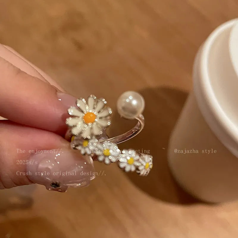 Women's copper opening ring with a sweet twin daisy design and pearl accent on a white background.