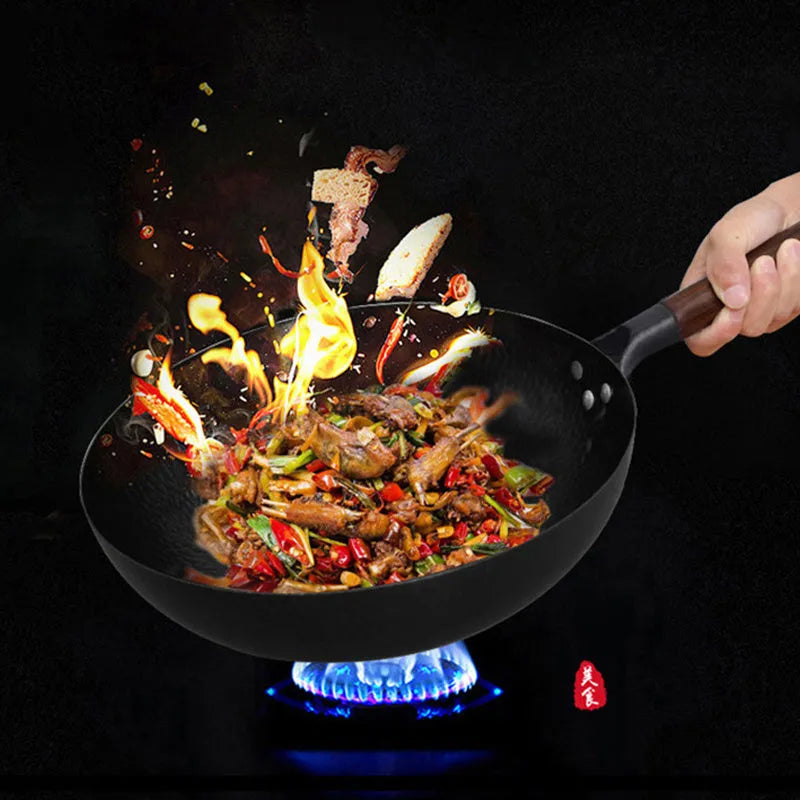 Black traditional iron wok with wooden handle, shown with glass lid.
