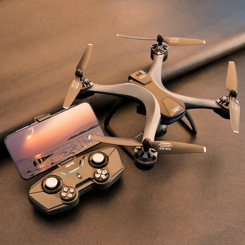 Plastic quadrocopter drone with remote controller, spare blades, and landing gear on a white background.