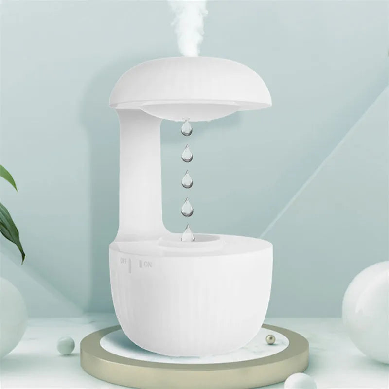 White anti-gravity levitating humidifier showing water droplets flowing upward with cool mist output