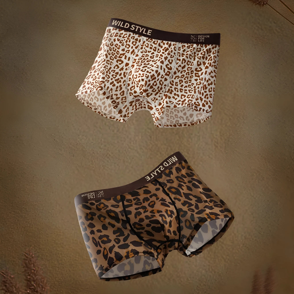 Men's leopard print ice silk underwear pants laid flat, showing mid-waist design and knitted polyester fabric.