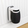 White automatic cat grooming brush mounted on a wall corner, showing USB cable and soft bristles.