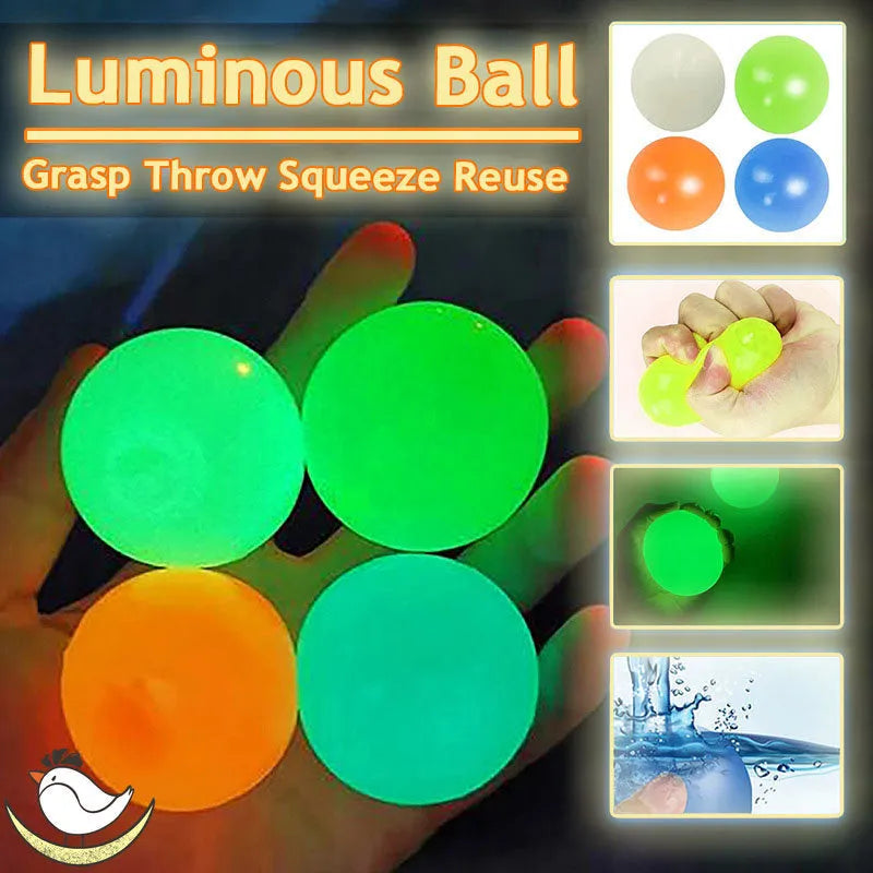 Luminous sticky ball toy in green colour glowing on a dark background, 4.5cm TPR squeeze ball for children
