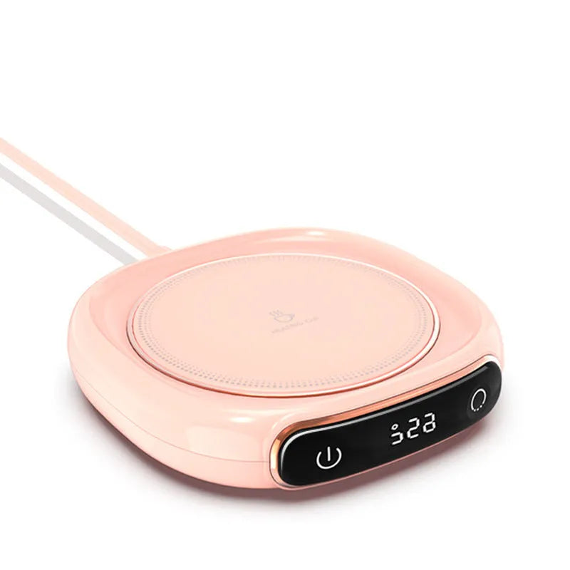 White USB-powered coffee mug warmer on desk heating a ceramic coffee cup