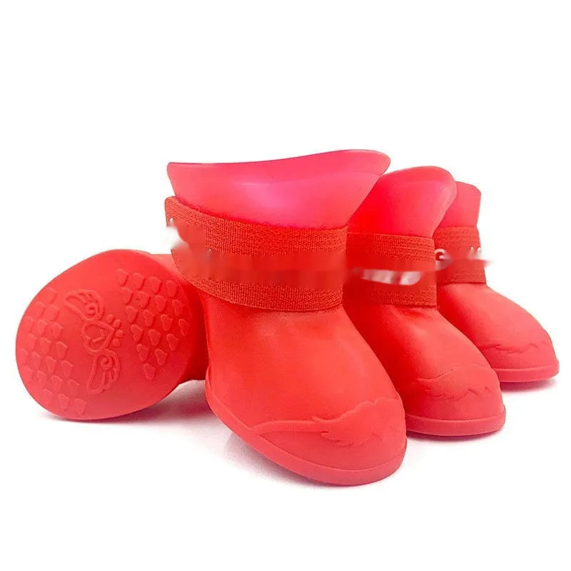 Four rubber pet rain shoes in various colours with anti-slip soles for dog paw protection